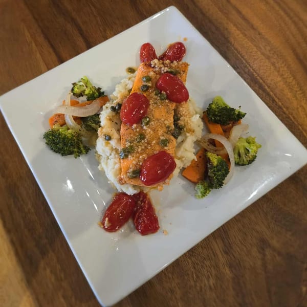 Rendezvous Bar & Grill's salmon with mashed potatoes, roasted vegetables, capers, and cherry tomatoes.